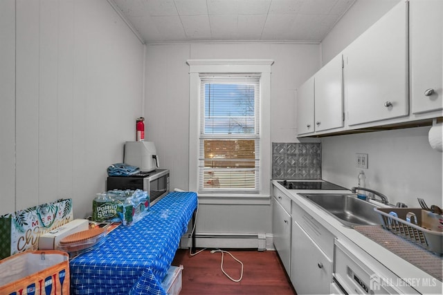 311 Magnolia St, Highland Park, NJ 08904 - kitchen with white cabinets, a sink, light countertops, dark wood-style floors, and a baseboard heating unit