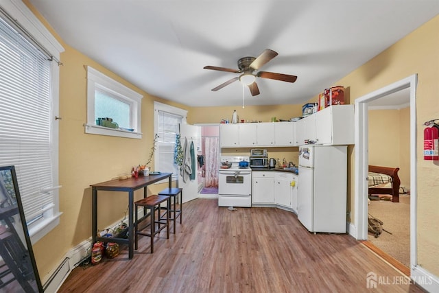 311 Magnolia St, Highland Park, NJ 08904 - kitchen featuring white appliances, wood finished floors, a ceiling fan, a sink, and white cabinetry