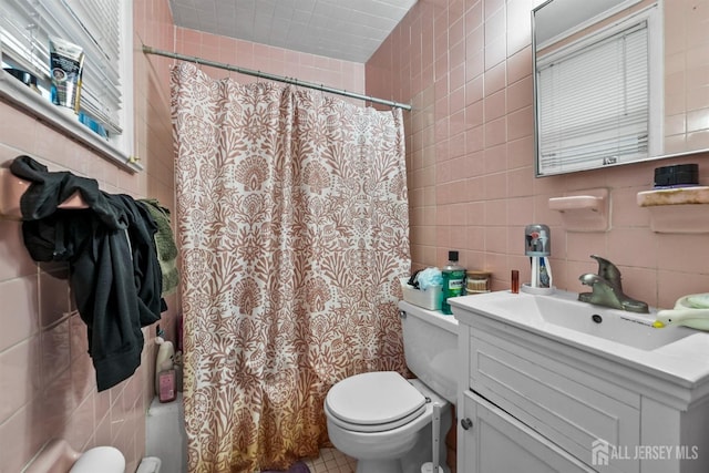 311 Magnolia St, Highland Park, NJ 08904 - full bathroom featuring vanity, a shower with curtain, toilet, tile walls, and decorative backsplash