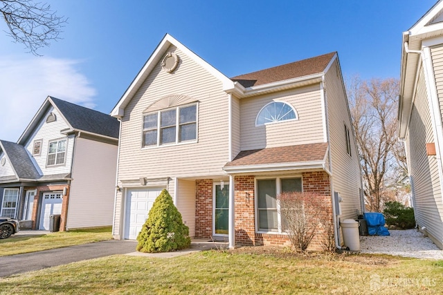 view of front of house with a front lawn and a garage