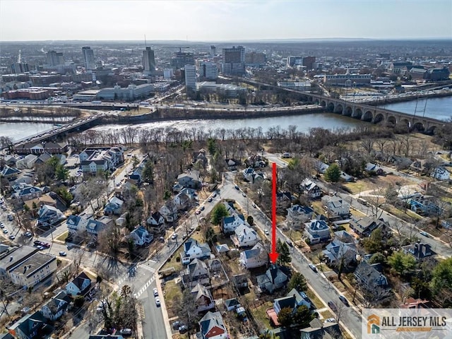 birds eye view of property with a view of city and a water view