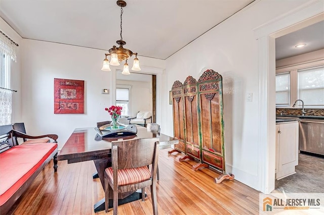 dining room with a notable chandelier and light wood-style floors