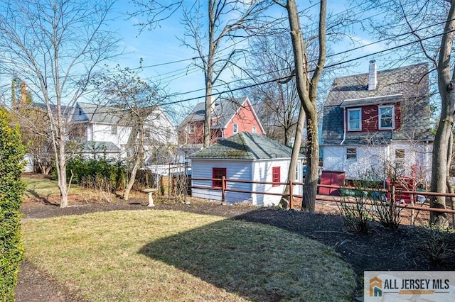 view of yard with an outbuilding and fence