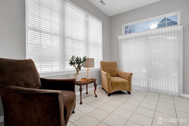 sitting room with baseboards, visible vents, and light tile patterned floors