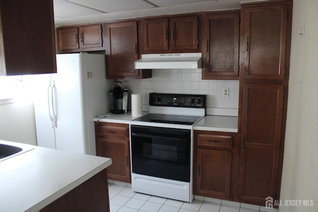 131-C Balsam Plz, Monroe, NJ 08831 - kitchen with under cabinet range hood, range with electric cooktop, tasteful backsplash, and light countertops