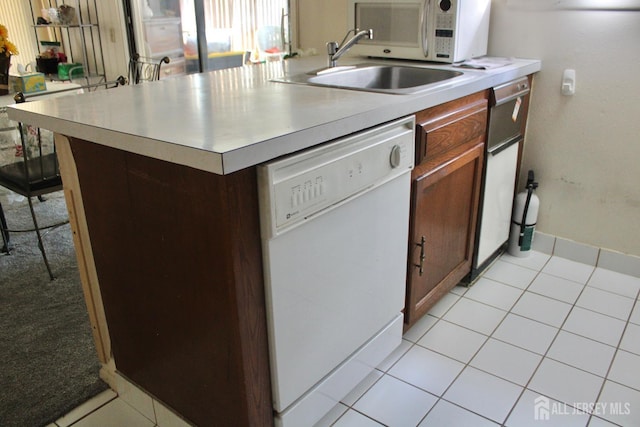131-C Balsam Plz, Monroe, NJ 08831 - kitchen with white appliances, light countertops, a breakfast bar, and light tile patterned floors