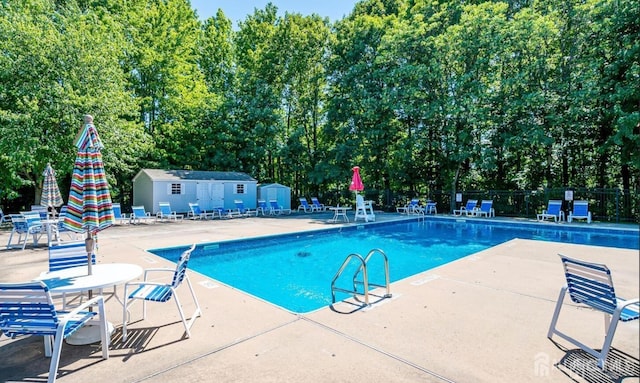 9 Lamberson Ct, Sayreville, NJ 08872 - community pool with a patio area, a shed, and view of scattered trees