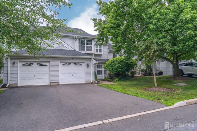 9 Lamberson Ct, Sayreville, NJ 08872 - traditional home featuring driveway, a garage, a front lawn, and roof with shingles