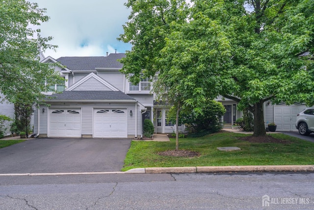 9 Lamberson Ct, Sayreville, NJ 08872 - view of front facade featuring asphalt driveway, a front lawn, and roof with shingles