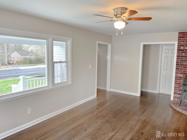 66 W Spring St W, Somerville, NJ 08876 - spare room with a wood stove, wood finished floors, and baseboards