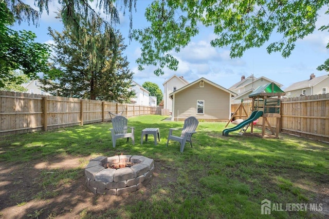 60 S St S, Milltown, NJ 08850 - fenced backyard with a fire pit and a playground
