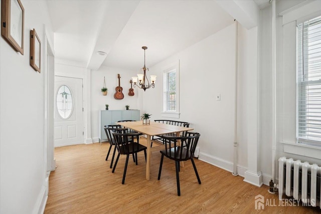 60 S St S, Milltown, NJ 08850 - dining space with radiator, light wood-style floors, and a chandelier