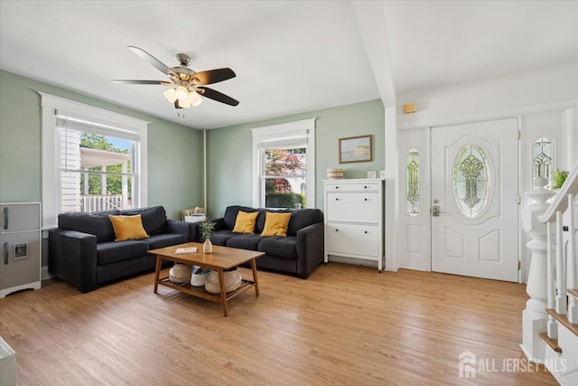 60 S St S, Milltown, NJ 08850 - living room featuring healthy amount of natural light, stairway, light wood finished floors, a ceiling fan, and beam ceiling