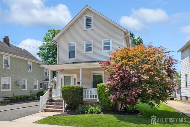 60 S St S, Milltown, NJ 08850 - traditional style home featuring covered porch, a front lawn, and cooling unit
