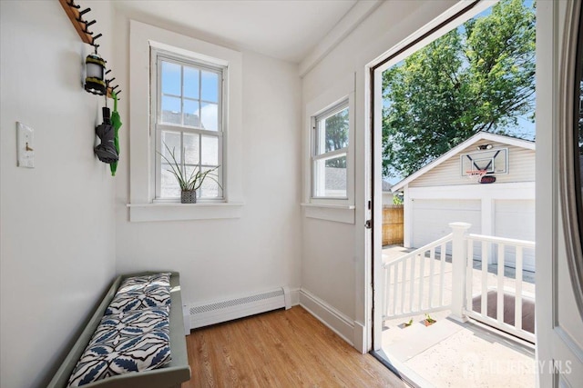 60 S St S, Milltown, NJ 08850 - doorway to outside with a baseboard radiator, plenty of natural light, and light wood finished floors
