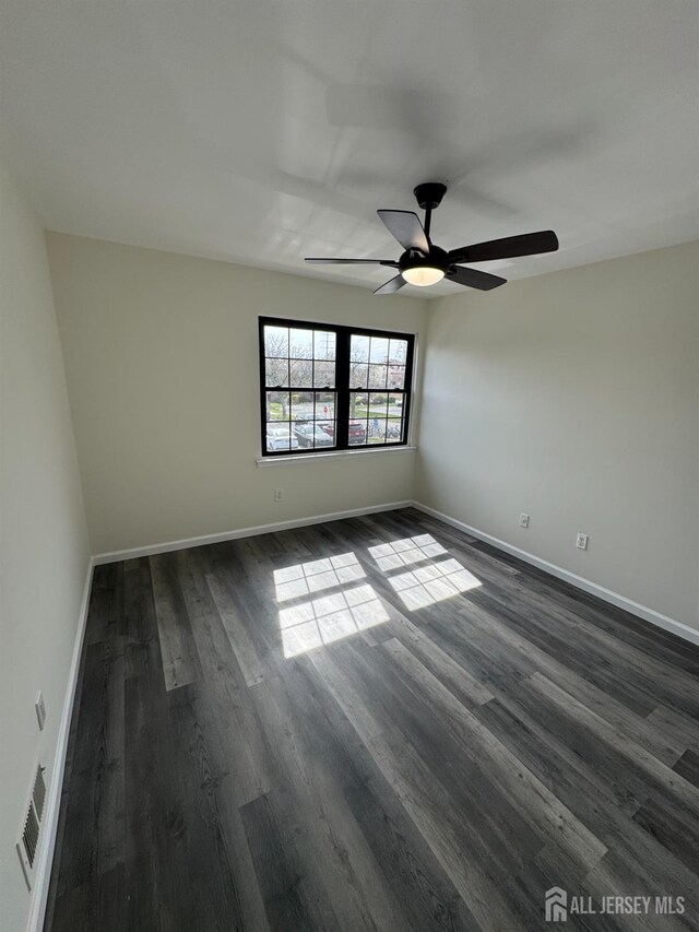 89 Golden Sq, Woodbridge Proper, NJ 07095 - spare room with dark wood-type flooring and a ceiling fan
