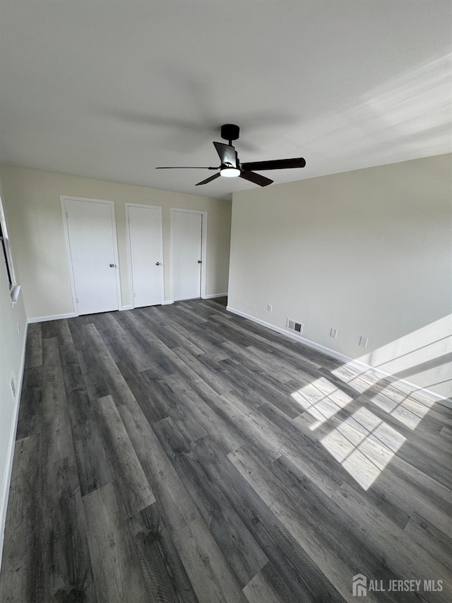 89 Golden Sq, Woodbridge Proper, NJ 07095 - unfurnished bedroom featuring dark wood-type flooring, two closets, and ceiling fan