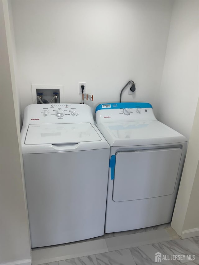 89 Golden Sq, Woodbridge Proper, NJ 07095 - laundry room featuring washing machine and clothes dryer and light marble finish flooring