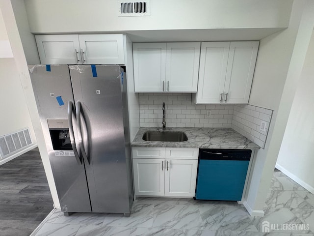 kitchen with stainless steel refrigerator with ice dispenser, dishwasher, light marble finish floors, and a sink