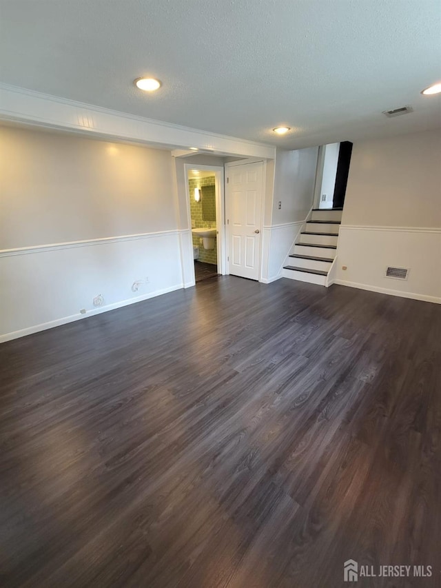 interior space with dark hardwood / wood-style floors and a textured ceiling