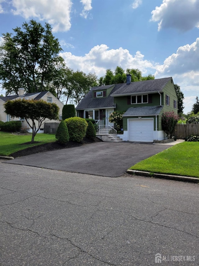 view of front of house with a garage and a front yard