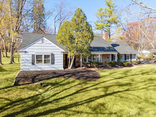 single story home featuring a front lawn