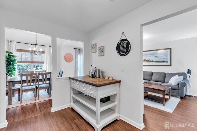 43 Capica Ct, South Amboy, NJ 08879 - corridor featuring a chandelier and dark wood-type flooring
