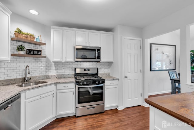 43 Capica Ct, South Amboy, NJ 08879 - kitchen featuring stainless steel appliances, open shelves, white cabinets, dark wood-style floors, and tasteful backsplash