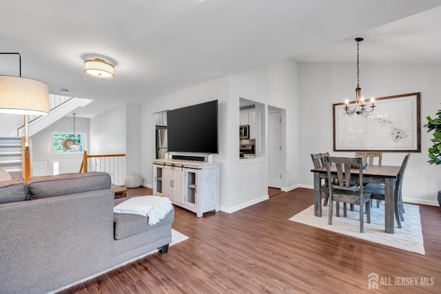 43 Capica Ct, South Amboy, NJ 08879 - living room with a chandelier, wood finished floors, lofted ceiling, and stairs