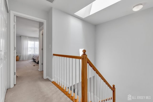 43 Capica Ct, South Amboy, NJ 08879 - hall featuring an upstairs landing, a skylight, and carpet