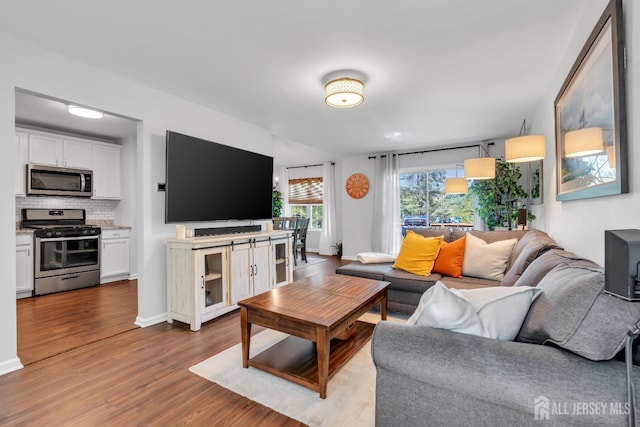 43 Capica Ct, South Amboy, NJ 08879 - living room featuring dark wood-style floors and baseboards