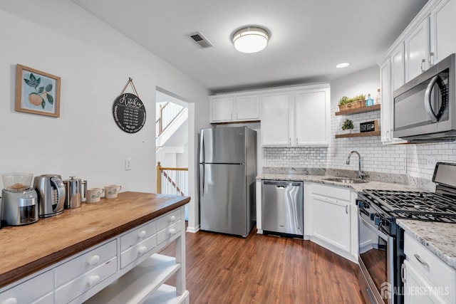 43 Capica Ct, South Amboy, NJ 08879 - kitchen featuring appliances with stainless steel finishes, open shelves, decorative backsplash, and white cabinets