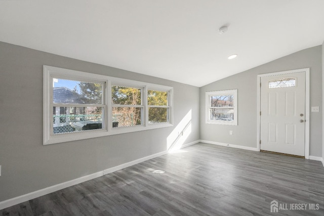 entrance foyer with baseboards, lofted ceiling, and wood finished floors