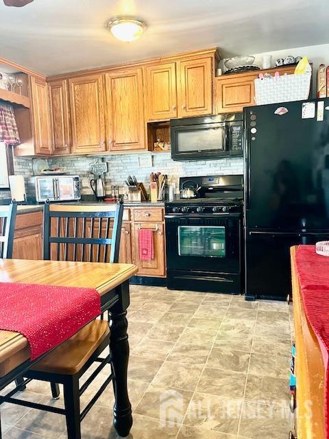 37 Kearney Ave, Keyport, NJ 07735 - kitchen with black appliances, tasteful backsplash, and open shelves