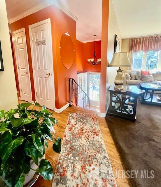 37 Kearney Ave, Keyport, NJ 07735 - entryway with ornamental molding, wood finished floors, and a chandelier