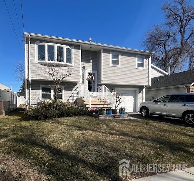 split foyer home with a front yard and a garage