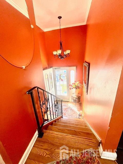 37 Kearney Ave, Keyport, NJ 07735 - stairway featuring a chandelier, crown molding, and wood finished floors