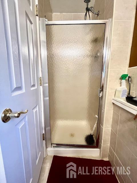 37 Kearney Ave, Keyport, NJ 07735 - bathroom featuring a stall shower and tile walls