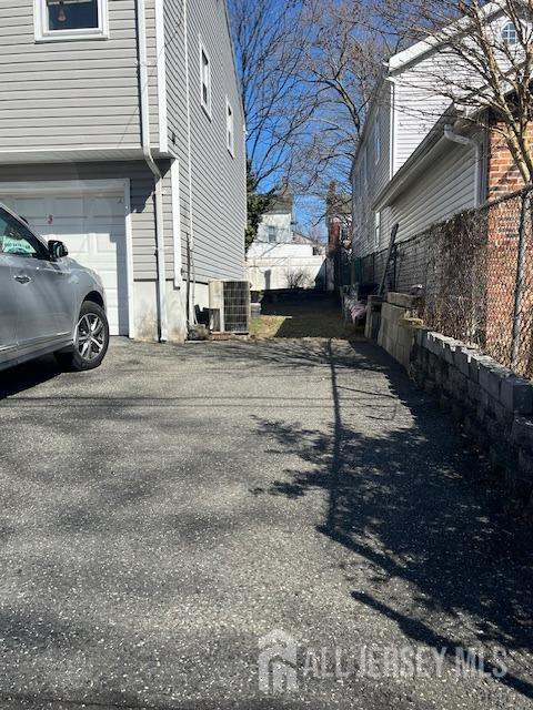 37 Kearney Ave, Keyport, NJ 07735 - view of side of home featuring asphalt driveway and a garage