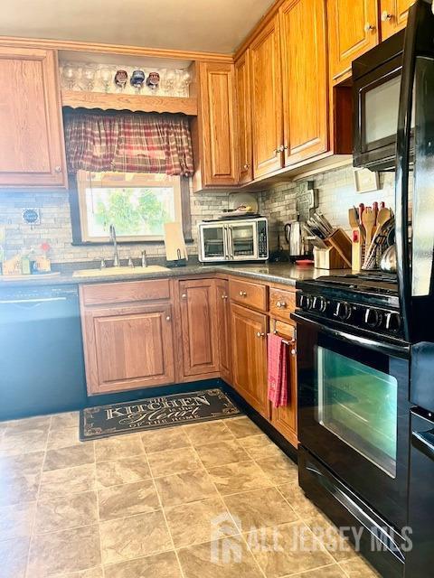 37 Kearney Ave, Keyport, NJ 07735 - kitchen featuring black appliances, decorative backsplash, and brown cabinetry