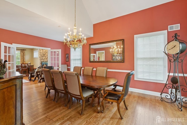 7 Pershing Ct, North Brunswick, NJ 08902 - dining room featuring a chandelier, lofted ceiling, and light wood-style floors