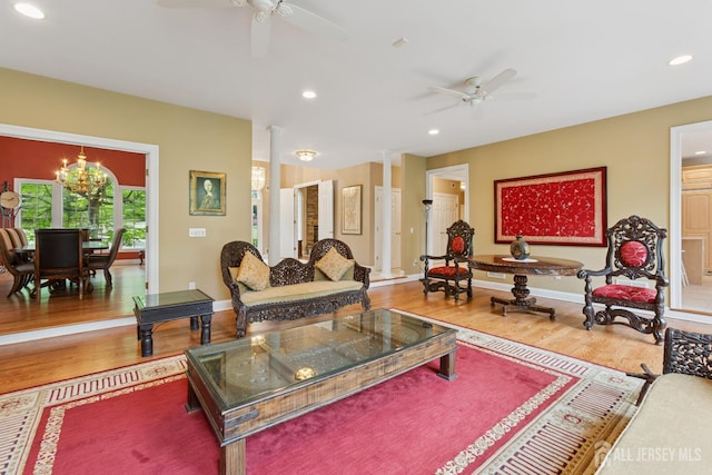 7 Pershing Ct, North Brunswick, NJ 08902 - living room with a ceiling fan, wood finished floors, recessed lighting, ornate columns, and a chandelier