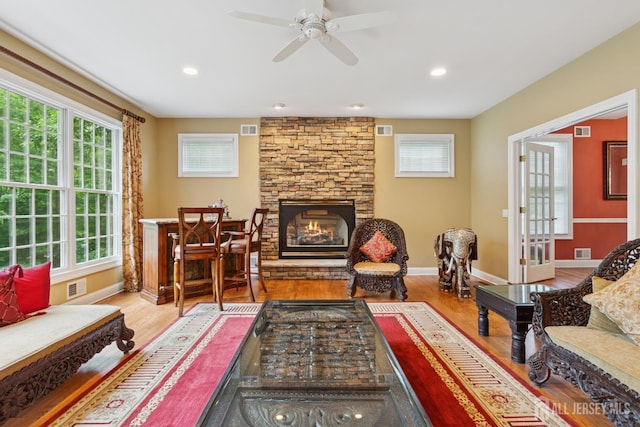 7 Pershing Ct, North Brunswick, NJ 08902 - living area with wood finished floors, a stone fireplace, a ceiling fan, and recessed lighting