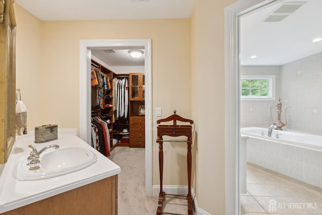 7 Pershing Ct, North Brunswick, NJ 08902 - full bathroom featuring a garden tub, a spacious closet, vanity, and tile patterned flooring