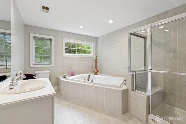 7 Pershing Ct, North Brunswick, NJ 08902 - full bath with tile patterned flooring, a garden tub, vanity, a stall shower, and tile walls