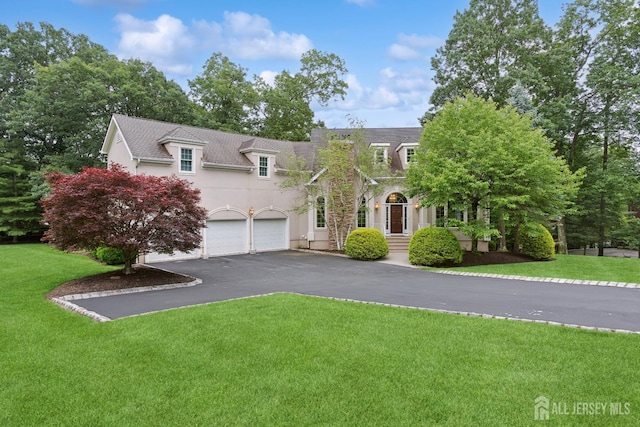 7 Pershing Ct, North Brunswick, NJ 08902 - view of front of property featuring driveway, a front lawn, stucco siding, and a garage
