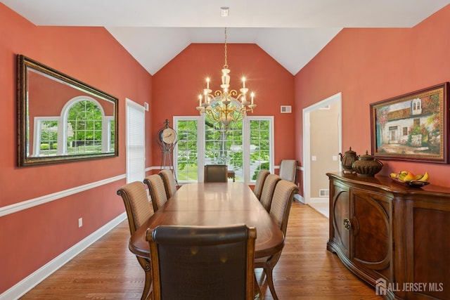 7 Pershing Ct, North Brunswick, NJ 08902 - dining space featuring a chandelier, wood finished floors, and high vaulted ceiling