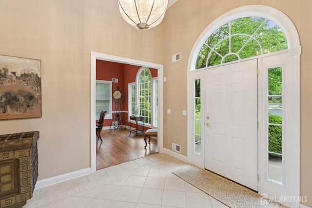 7 Pershing Ct, North Brunswick, NJ 08902 - entrance foyer featuring light tile patterned flooring, a towering ceiling, and a chandelier