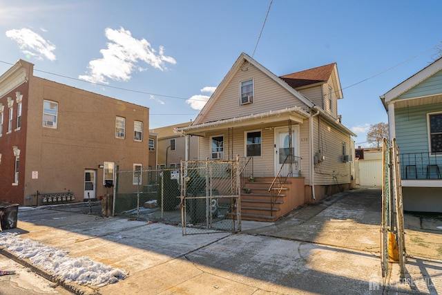 view of front of house featuring a porch, a gate, and a fenced front yard