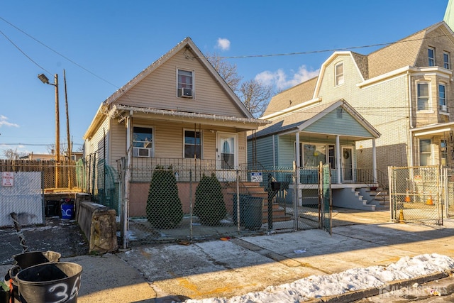 view of front of house with a porch, a gate, and a fenced front yard